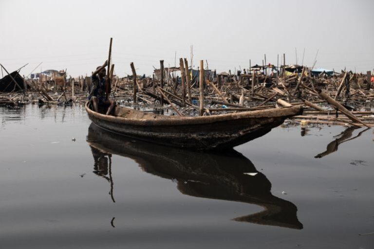 A boy paddles past the ruins after demolitions in Makoko, Lagos, Nigeria. | Pelumi Salako/Al Jazeera