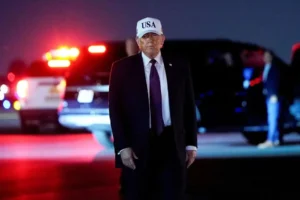 President Donald Trump looks on after disembarking Air Force One at Palm Beach International Airport in West Palm Beach, Florida. | Elizabeth Frantz/REUTERS