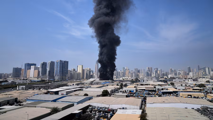 A black smoke rises from a warehouse at the industrial area of Sharjah City in the United Arab Emirates following reports of Iranian strikes in Dubai, United Arab Emirates, Sunday. | ALTAF QADRI / AP