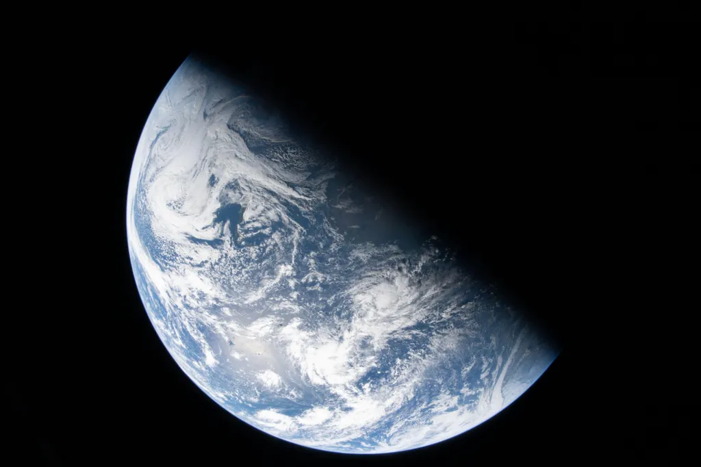  Image taken by the crew shows the divide between night and day, known as the terminator, cutting across Earth